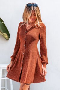 Model wearing Cupshe Bonfire Babe Orange Mini Dress on the beach